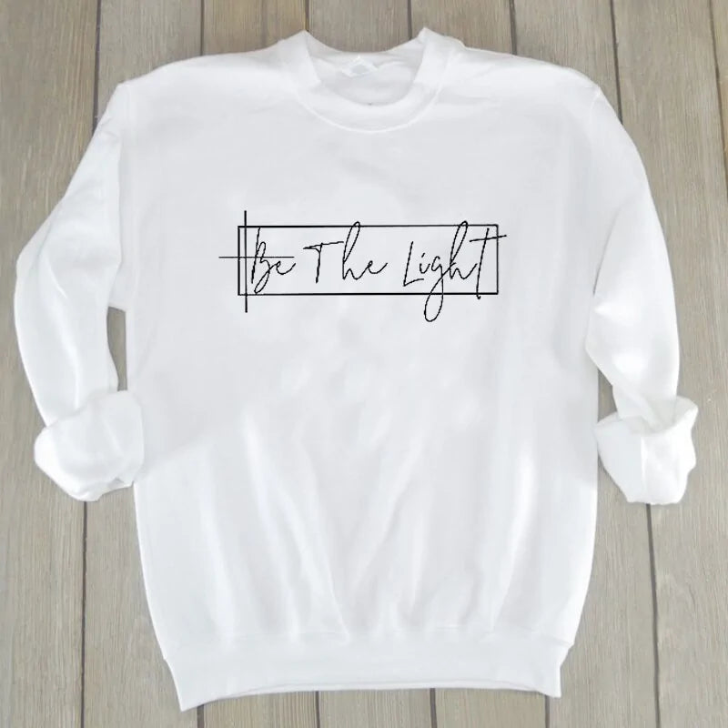 Unisex Christian Sweatshirt: Featuring 'Be The Light' motif.