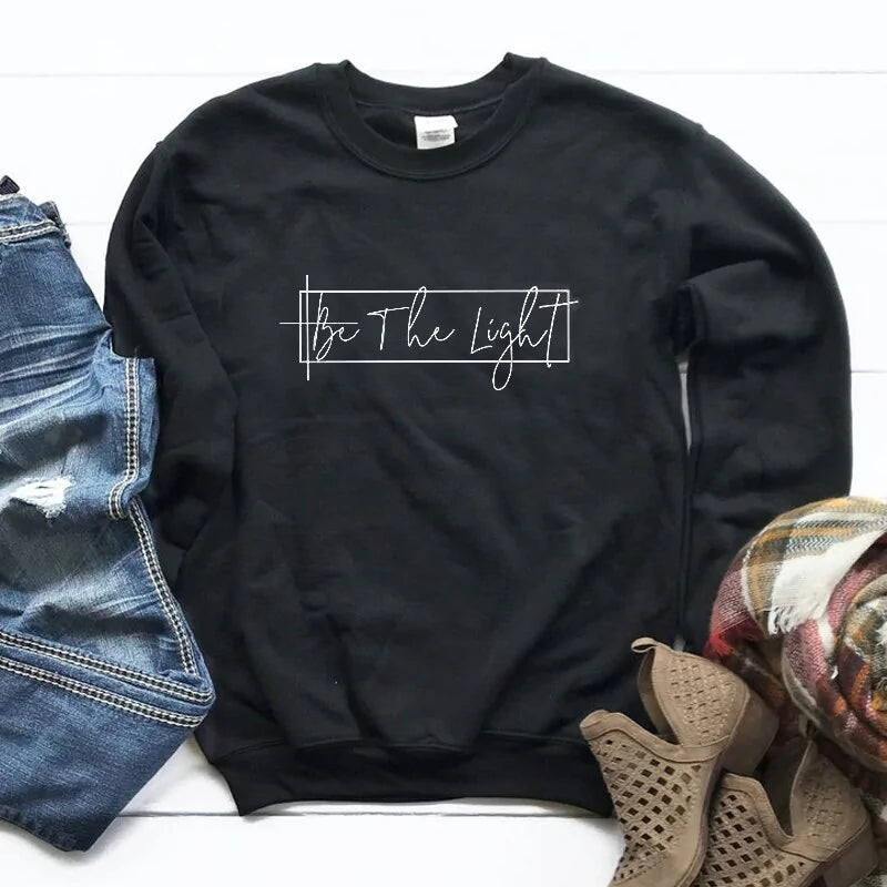 Unisex Christian Sweatshirt: Featuring 'Be The Light' motif.